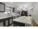 Eat-in kitchen showcases an island with seating, updated appliances, and decorative lighting at 43283 W Hillman Dr, Maricopa, AZ 85138