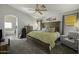 Spacious main bedroom featuring a large bed, ample natural light, and access to an ensuite bathroom at 43283 W Hillman Dr, Maricopa, AZ 85138