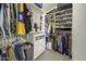 Spacious walk-in closet offers ample storage with custom shelving and hanging rods for organized clothing and accessories at 43283 W Hillman Dr, Maricopa, AZ 85138