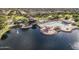 Aerial view of the community featuring a lake, pool, clubhouse, and green spaces at 43344 W Oster Dr, Maricopa, AZ 85138