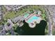 Community amenities with a pool, clubhouse, and splash pad, connected by winding sidewalks and green spaces at 43344 W Oster Dr, Maricopa, AZ 85138