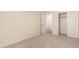 Bedroom featuring carpeted floors, neutral walls, and closet with sliding doors at 43344 W Oster Dr, Maricopa, AZ 85138