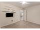Spacious carpeted bedroom with a ceiling fan and shelving at 43344 W Oster Dr, Maricopa, AZ 85138