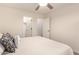 Cozy bedroom featuring a ceiling fan and access to a walk-in closet at 43344 W Oster Dr, Maricopa, AZ 85138