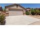 Charming single-Gathering home with desert landscaping, covered entry, and a two-car garage at 43344 W Oster Dr, Maricopa, AZ 85138