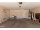 Clean garage with ample storage, a utility sink, and access doors at 43344 W Oster Dr, Maricopa, AZ 85138