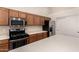 Modern kitchen with stainless steel appliances, tile backsplash, and ample counter space at 43344 W Oster Dr, Maricopa, AZ 85138