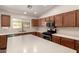 Modern kitchen with stainless steel appliances, island with counter seating, and tile backsplash at 43344 W Oster Dr, Maricopa, AZ 85138