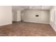Bright, open-concept living room with tile flooring, plantation shutters, and a ceiling fan at 43344 W Oster Dr, Maricopa, AZ 85138
