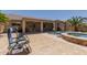 Back patio with a swimming pool and covered area. Perfect spot for relaxation or entertaining guests at 43344 W Oster Dr, Maricopa, AZ 85138