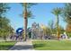 Community playground with various play structures, seating areas, and well-maintained landscaping at 43344 W Oster Dr, Maricopa, AZ 85138