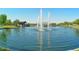 Beautiful community pond featuring a trio of fountains adding a touch of elegance to the neighborhood at 43344 W Oster Dr, Maricopa, AZ 85138