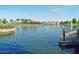 Scenic pond with fountains and a charming pier, providing a serene community waterfront setting at 43344 W Oster Dr, Maricopa, AZ 85138