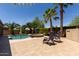 Relaxing backyard pool and spa with mature palm trees offering shade and privacy on a sunny day at 43344 W Oster Dr, Maricopa, AZ 85138