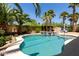 Inviting pool and spa with lush tropical landscaping and sunny skies at 43344 W Oster Dr, Maricopa, AZ 85138