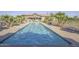 Inviting community swimming pool with clear blue water, surrounded by lounge chairs and lush landscaping at 43344 W Oster Dr, Maricopa, AZ 85138
