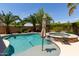 Beautiful pool and spa surrounded by palm trees, providing a relaxing outdoor space at 43344 W Oster Dr, Maricopa, AZ 85138