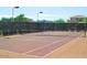 Well-maintained community tennis court with new nets, fencing, and lighting for evening play at 43344 W Oster Dr, Maricopa, AZ 85138