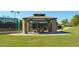 Community tennis court viewing area with a covered ramada for seating and shade at 43344 W Oster Dr, Maricopa, AZ 85138