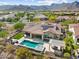 Wonderful aerial view of home with pool, spa, outdoor kitchen, and mountain views at 5033 N 205Th Gln, Buckeye, AZ 85396