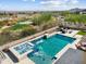 Aerial view of a backyard oasis with a pool, spa, fire pit, and manicured landscaping at 5033 N 205Th Gln, Buckeye, AZ 85396