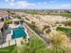 Wonderful aerial view of backyard pool, spa, outdoor kitchen and desert landscape at 5033 N 205Th Gln, Buckeye, AZ 85396