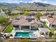 Great aerial view of house with pool, spa, outdoor kitchen and artificial turf at 5033 N 205Th Gln, Buckeye, AZ 85396