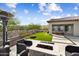 Expansive backyard with artificial turf, fire pit, desert landscape, and covered patio at 5033 N 205Th Gln, Buckeye, AZ 85396