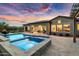 Relaxing backyard and pool view with covered patio, spa, and sunset skies at 5033 N 205Th Gln, Buckeye, AZ 85396