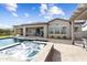 Resort-style backyard with a pool, spa, covered patio, and lush landscaping at 5033 N 205Th Gln, Buckeye, AZ 85396