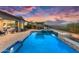 Beautiful backyard showcasing a pool, outdoor kitchen, and desert landscaping at 5033 N 205Th Gln, Buckeye, AZ 85396