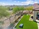 Expansive backyard featuring artificial turf, desert landscaping, and mountain views at 5033 N 205Th Gln, Buckeye, AZ 85396