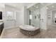 This bright bathroom features an elegant tub and separate glass-enclosed shower at 5033 N 205Th Gln, Buckeye, AZ 85396