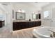A well-lit main bathroom features double sinks and a jetted tub at 5033 N 205Th Gln, Buckeye, AZ 85396