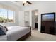 A bright bedroom features ensuite bathroom, walk-in closet, and large view window at 5033 N 205Th Gln, Buckeye, AZ 85396