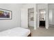 Cozy bedroom with an open closet and a glimpse into a well-lit bathroom at 5033 N 205Th Gln, Buckeye, AZ 85396