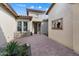 Charming courtyard with brick pavers, patio furniture, and lush desert landscaping, offering a private outdoor space at 5033 N 205Th Gln, Buckeye, AZ 85396
