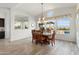 Bright dining room with large windows overlooking the pool and backyard at 5033 N 205Th Gln, Buckeye, AZ 85396