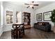 Inviting dining area with a ceiling fan, stylish furniture, and large windows bringing natural light at 5033 N 205Th Gln, Buckeye, AZ 85396
