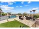 Outdoor living space showcasing a pool, fire pit, and landscaped turf area at 5033 N 205Th Gln, Buckeye, AZ 85396