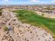 Scenic aerial view of the golf course featuring lush green fairways and well-manicured greens at 5033 N 205Th Gln, Buckeye, AZ 85396