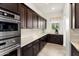 Spacious kitchen with stainless steel appliances, ample counter space, and dark wood cabinets at 5033 N 205Th Gln, Buckeye, AZ 85396
