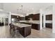 Spacious kitchen featuring a large center island, modern appliances, and elegant cabinetry at 5033 N 205Th Gln, Buckeye, AZ 85396