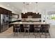 Gourmet kitchen with stainless steel appliances, expansive island, and bar stool seating at 5033 N 205Th Gln, Buckeye, AZ 85396