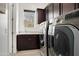 A well-equipped laundry room features side-by-side washer and dryer, and storage at 5033 N 205Th Gln, Buckeye, AZ 85396