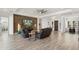 Modern living room featuring a stacked stone accent wall and a large flatscreen TV at 5033 N 205Th Gln, Buckeye, AZ 85396