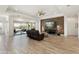 Large living room with wood-look flooring, a ceiling fan, and a sliding glass door that leads to an outdoor space at 5033 N 205Th Gln, Buckeye, AZ 85396
