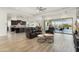 Open-concept living space with dark cabinets, an island, and a wall of windows overlooking a pool area at 5033 N 205Th Gln, Buckeye, AZ 85396