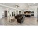 Open-concept living room featuring hardwood floors, modern lighting, and seamless access to a gourmet kitchen at 5033 N 205Th Gln, Buckeye, AZ 85396