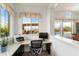 Bright home office with built-in desk, granite counter, large windows, and pool views at 5033 N 205Th Gln, Buckeye, AZ 85396